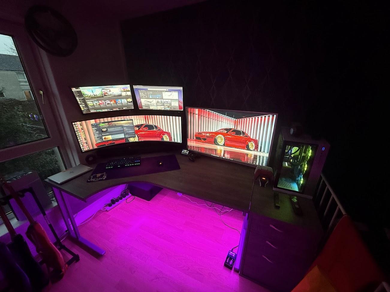 Calvin’s home desk and computer with colourful lighting in the evening