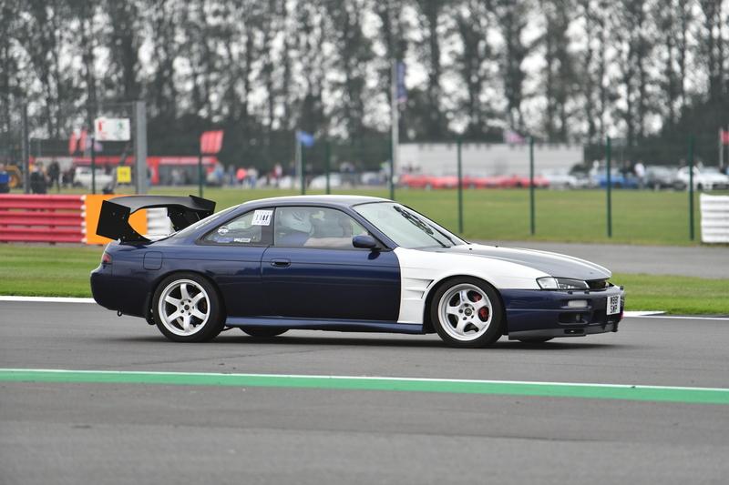 Calvin driving his blue and white Nissan S14 on track at Silverstone